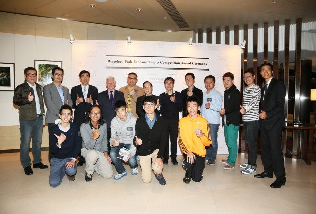 Mr. Edward Stokes, Judge of the Competition (fourth left, back row), Mr. Douglas Woo, Chairman of Wheelock and Company (first right, back row), Mr. Stewart Leung, Chairman of Wheelock Properties (sixth left, back row) and Mr. Ricky Wong, Managing Director of Wheelock Properties (third left, back row) presented certificates and prizes to Wheelock Peak Exposure Photo Competition winners.